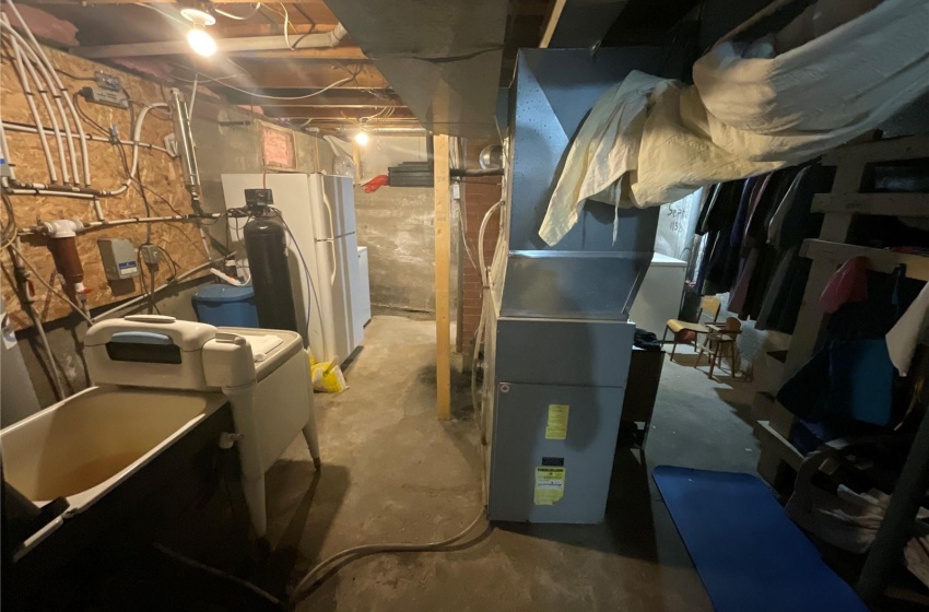 Basement with white refrigerator