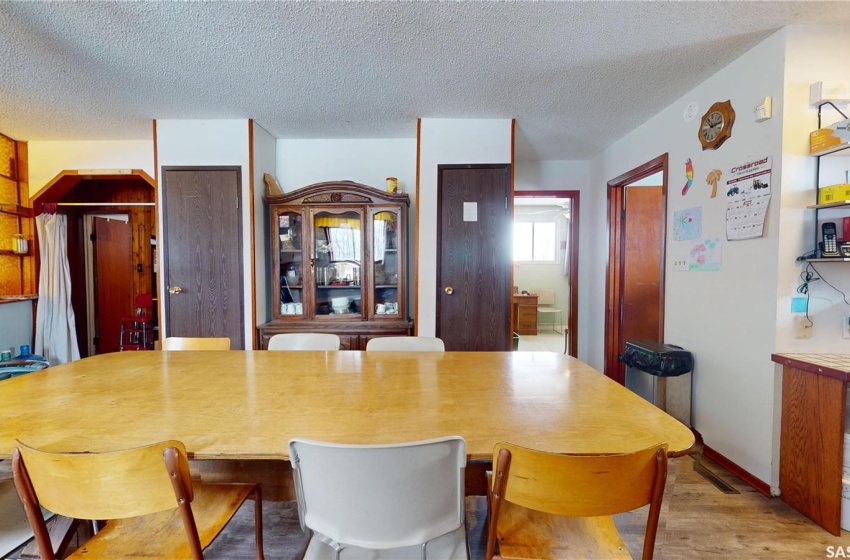 Dining room with a textured ceiling and light wood-type flooring