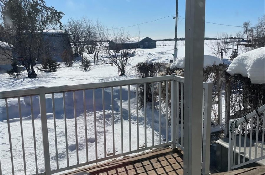 Covered entrance deck faces yard and South