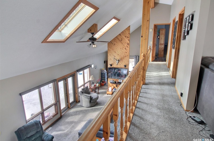 Hallway with high vaulted ceiling overlooking main floor