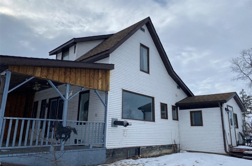 View of snow covered exterior featuring covered porch