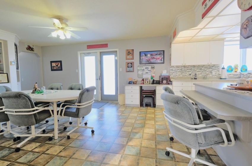 Dining area featuring light tile floors, french doors, and ceiling fan