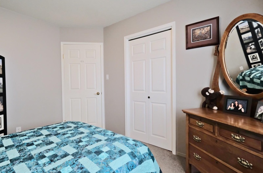 Bedroom featuring light carpet and a closet