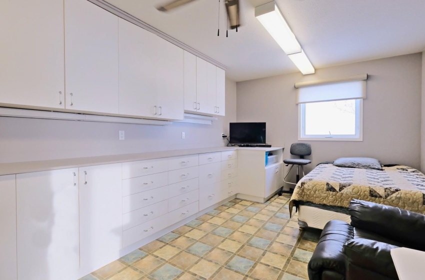 Bedroom featuring light tile floors and ceiling fan