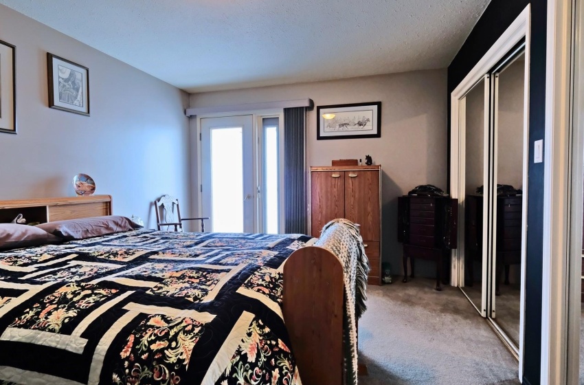 Carpeted bedroom featuring a closet and a textured ceiling