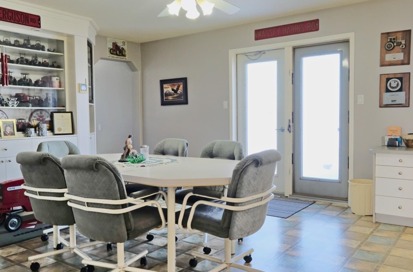 Tiled dining room with a wealth of natural light and ceiling fan