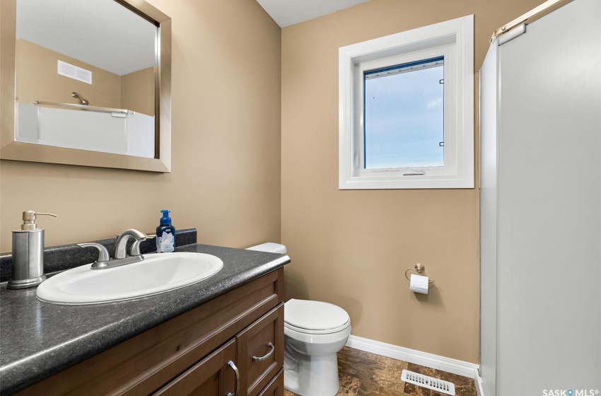 Bathroom featuring toilet, tile flooring, and large vanity