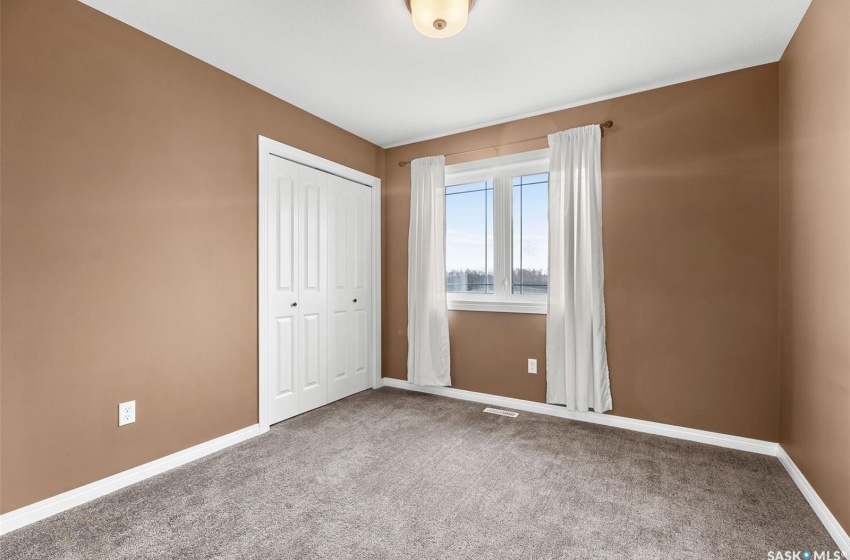 Unfurnished bedroom featuring carpet floors and a closet