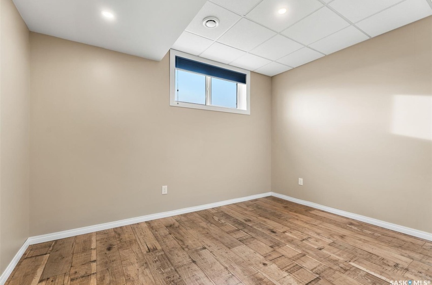 Unfurnished room featuring a paneled ceiling and light hardwood / wood-style floors