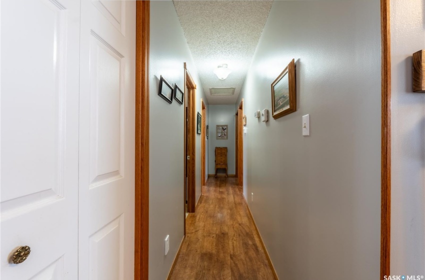 Hall featuring hardwood / wood-style flooring and a textured ceiling