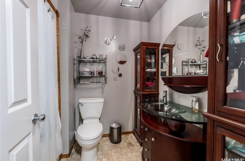 Bathroom with toilet, oversized vanity, and tile floors