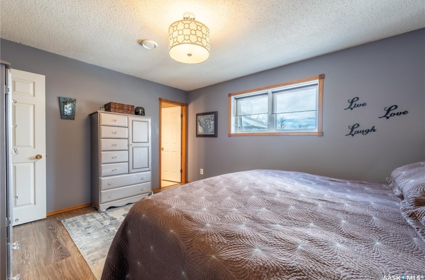 Bedroom featuring wood-type flooring and a textured ceiling