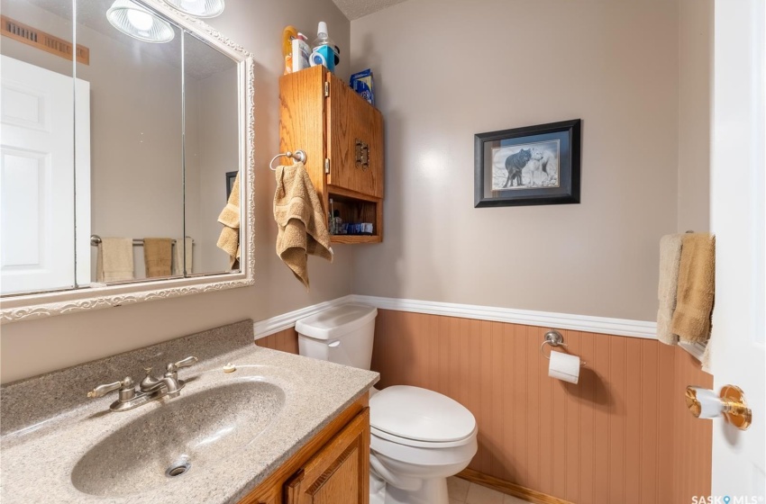 Bathroom featuring vanity, toilet, and tile floors