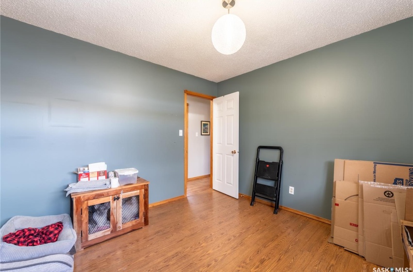 Recreation room featuring a textured ceiling and light hardwood / wood-style flooring