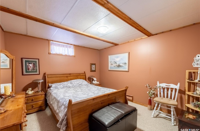 Carpeted bedroom with a baseboard radiator