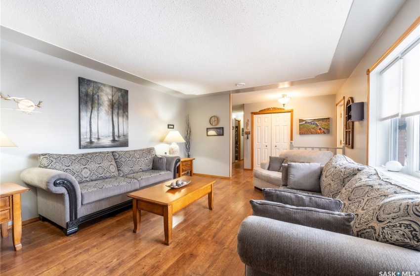 Living room featuring a textured ceiling and light hardwood / wood-style floors