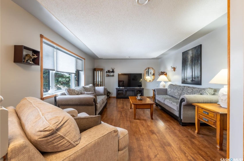 Living room with dark wood-type flooring and a textured ceiling