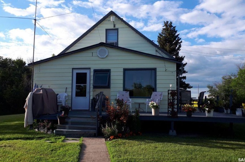 View of front of house with a deck and a front yard