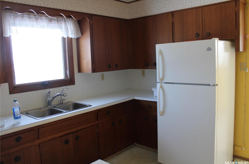 Kitchen featuring sink and white refrigerator