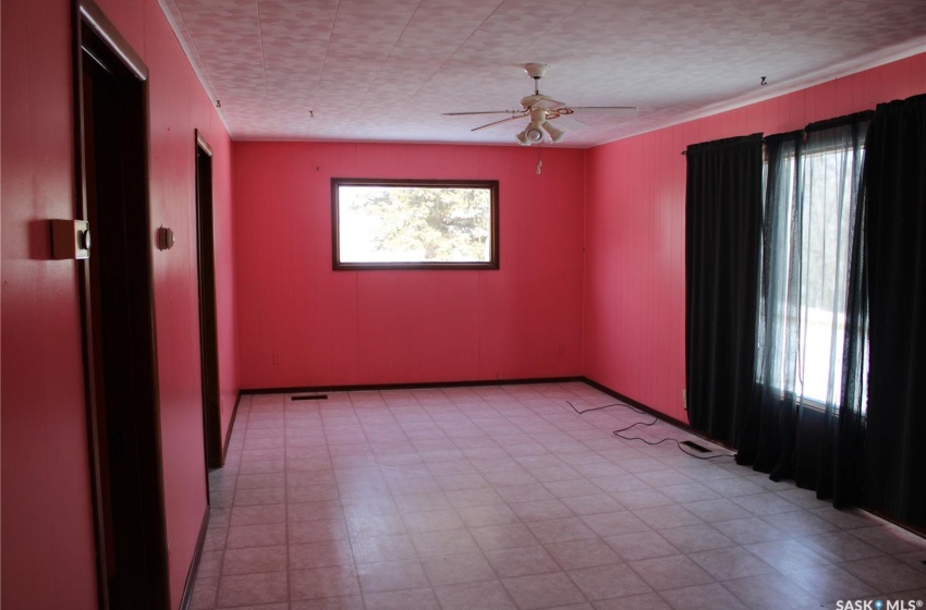 Tiled empty room featuring ceiling fan