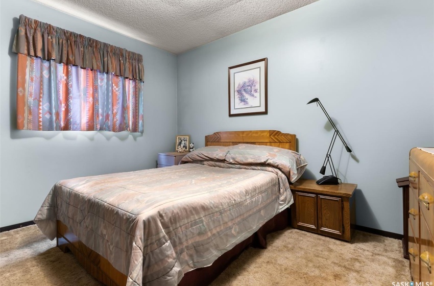 Carpeted bedroom with a textured ceiling