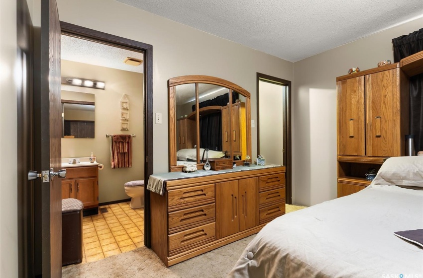 Bedroom with light tile flooring and a textured ceiling