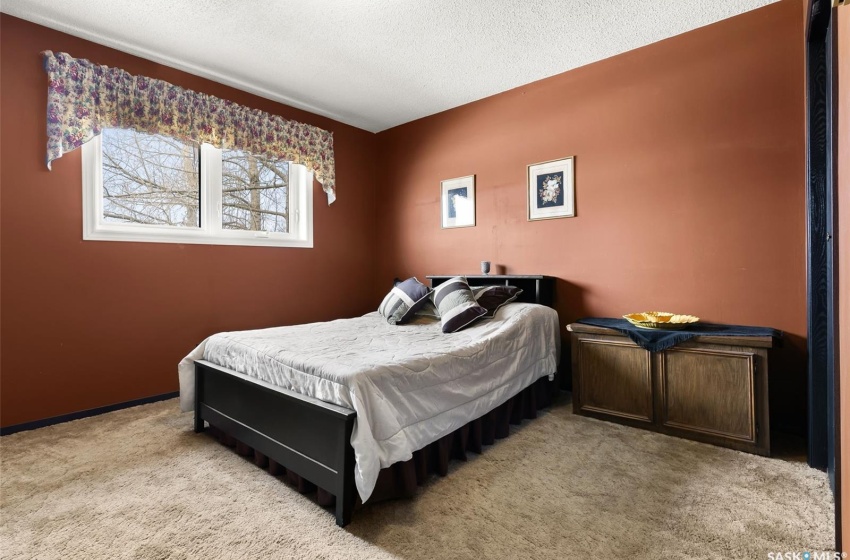 Carpeted bedroom with a textured ceiling