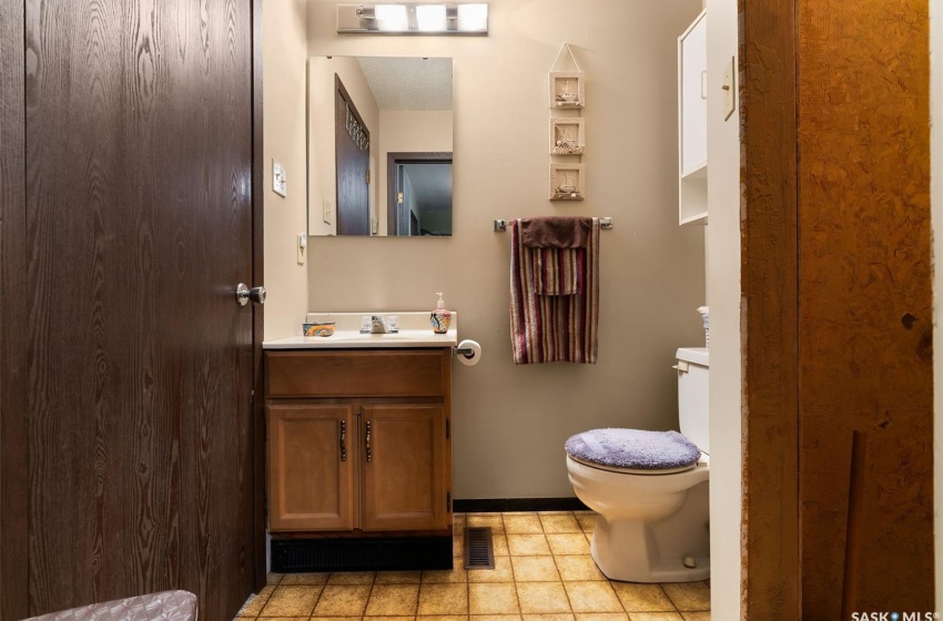 Bathroom featuring tile floors, vanity, and toilet