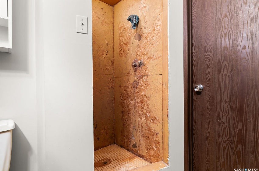 Bathroom with toilet and tiled shower