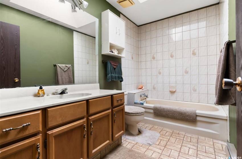 Full bathroom featuring vanity, shower / tub combination, toilet, and tile flooring