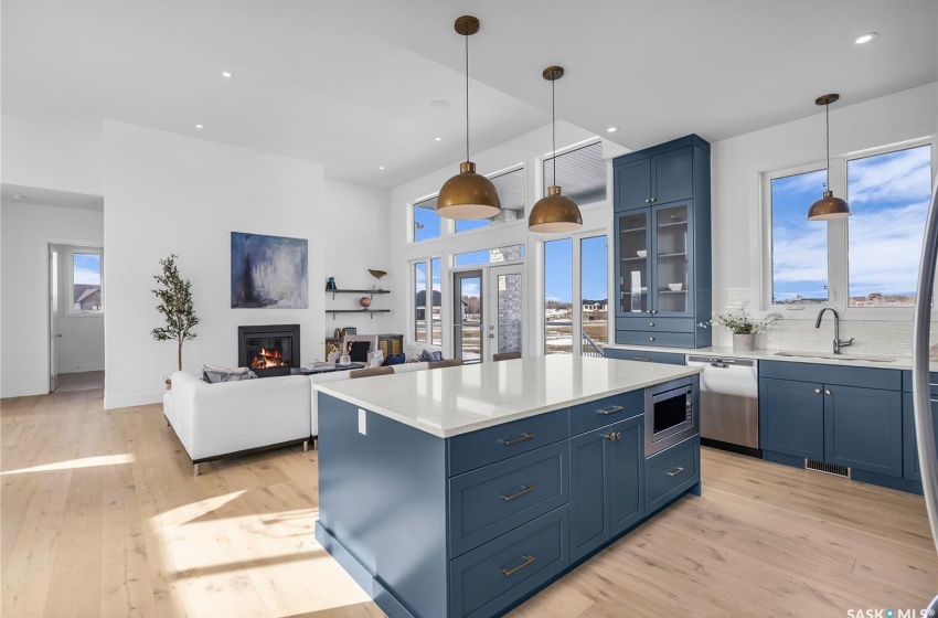 Kitchen featuring a center island, tasteful backsplash, exhaust hood and appliances with stainless steel finishes.