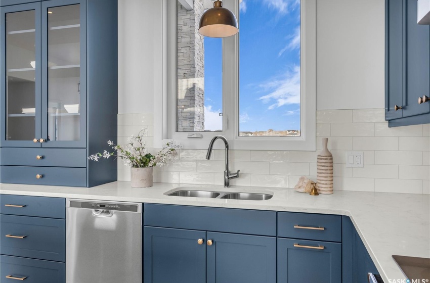 Kitchen featuring a center island, tasteful backsplash, exhaust hood and appliances with stainless steel finishes.