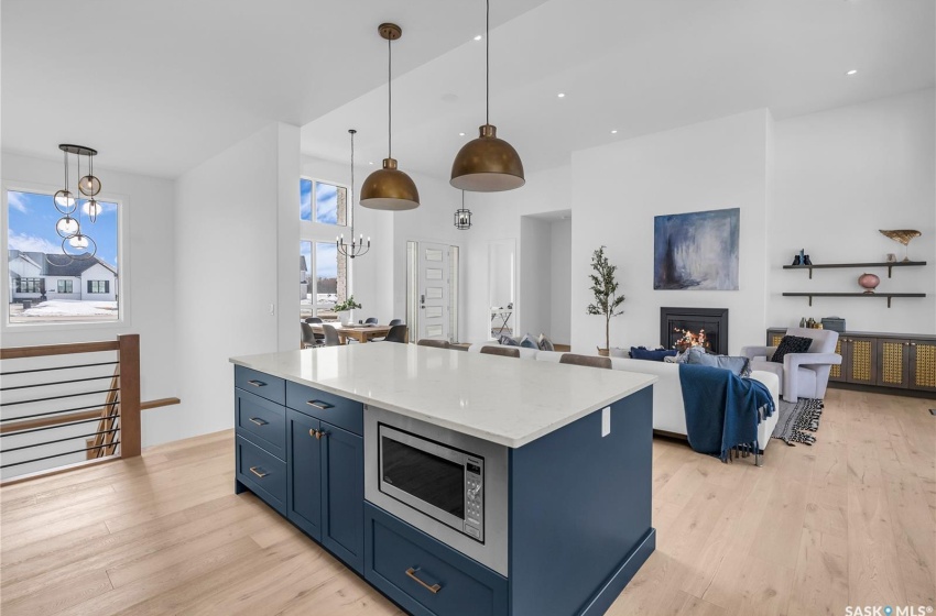 Kitchen featuring a center island, tasteful backsplash, exhaust hood and appliances with stainless steel finishes.