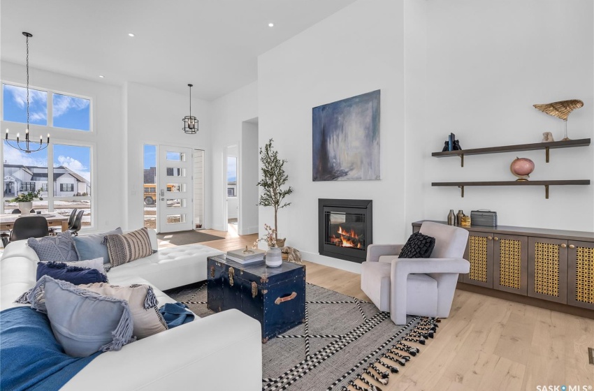 Living room featuring plenty of natural light, gas fireplace and light flooring.