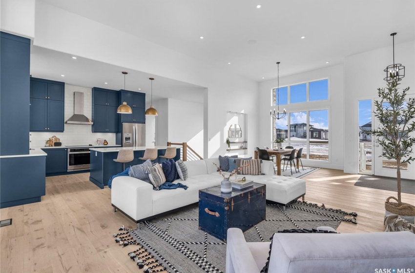 Living room featuring plenty of natural light, gas fireplace and light flooring.