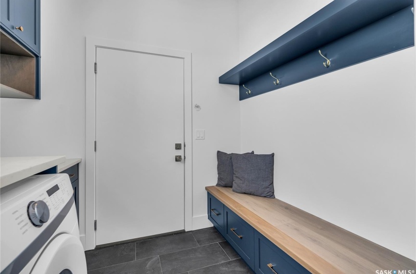 Mudroom with washer / dryer and dark tile floors