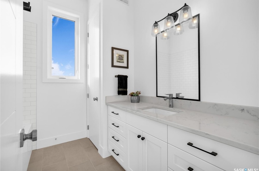 Bathroom with tile floors and vanity with extensive cabinet space