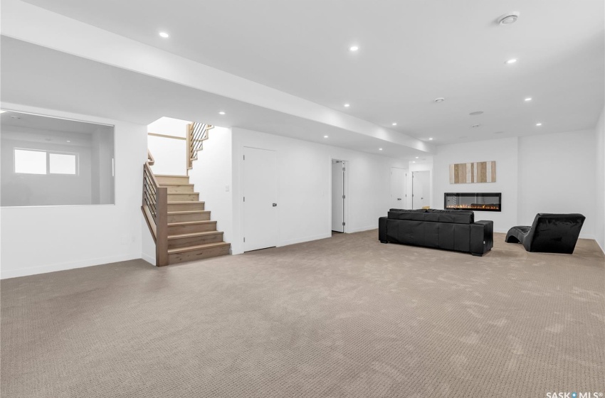 Finished basement with light colored carpet, gym area and 2 bedrooms.