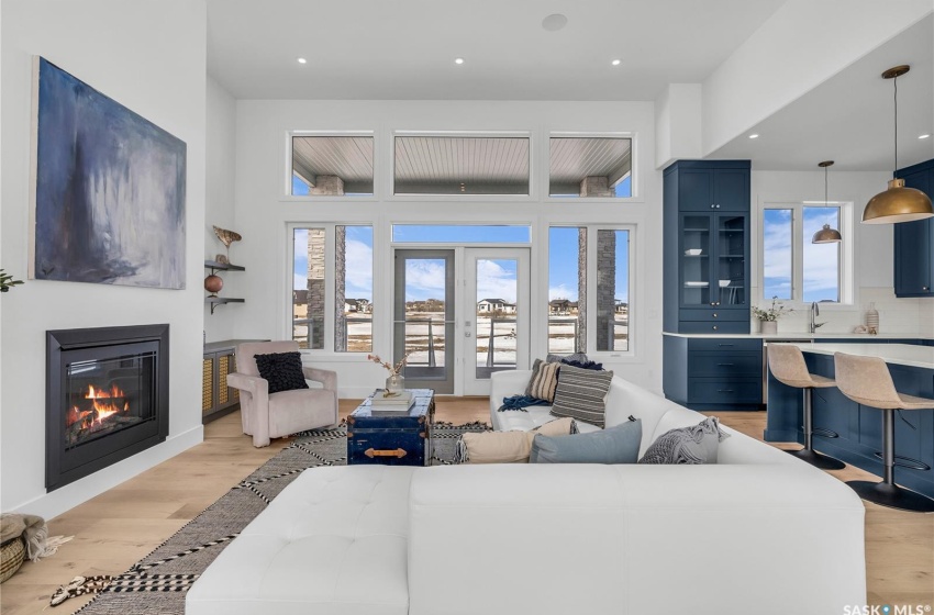 Living room featuring light flooring and high ceiling.