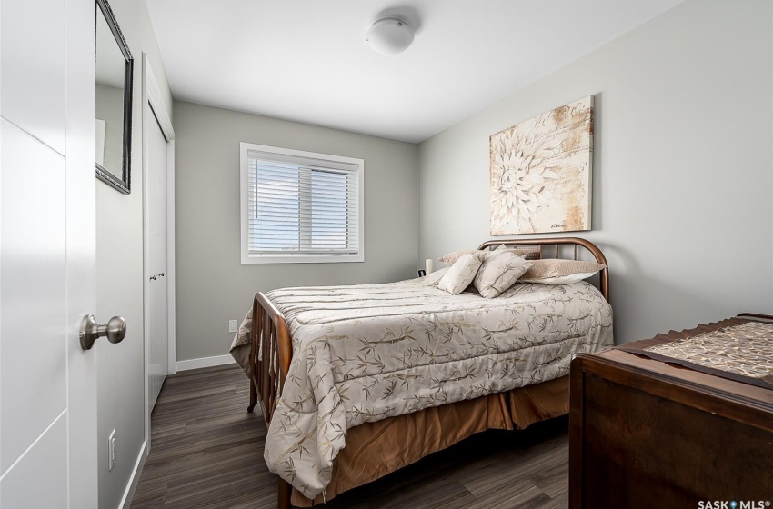 Bedroom with dark hardwood / wood-style flooring