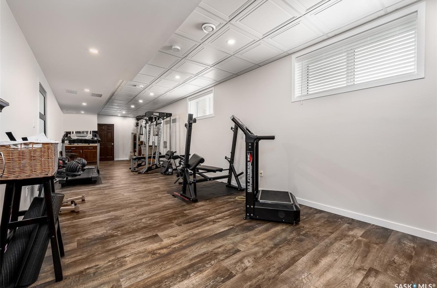 Workout room featuring dark hardwood / wood-style flooring