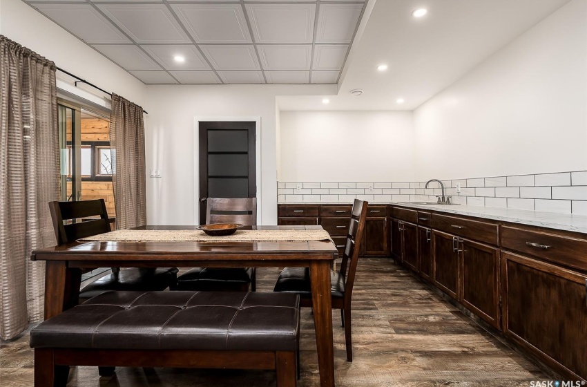 Dining area featuring sink and dark hardwood / wood-style floors