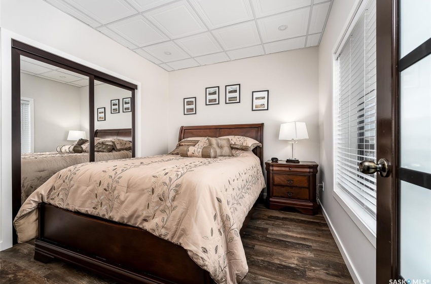 Bedroom with a closet and dark hardwood / wood-style floors