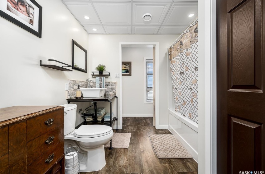 Bathroom with coffered ceiling, vanity, hardwood / wood-style flooring, and toilet