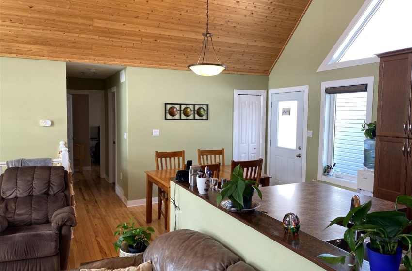 Living room featuring wooden ceiling, high vaulted ceiling, and light hardwood / wood-style floors