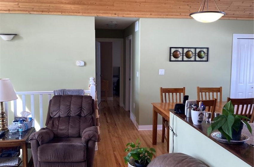 Living room with wooden ceiling and light hardwood / wood-style floors