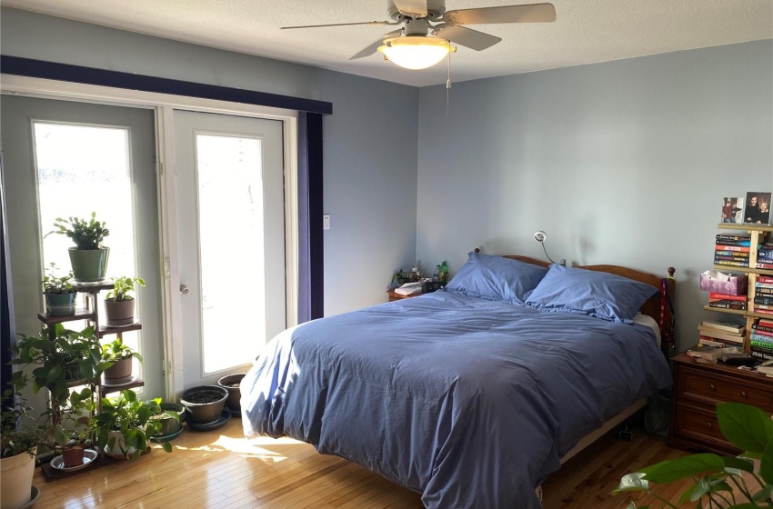 Bedroom featuring a textured ceiling, ceiling fan, and hardwood / wood-style flooring