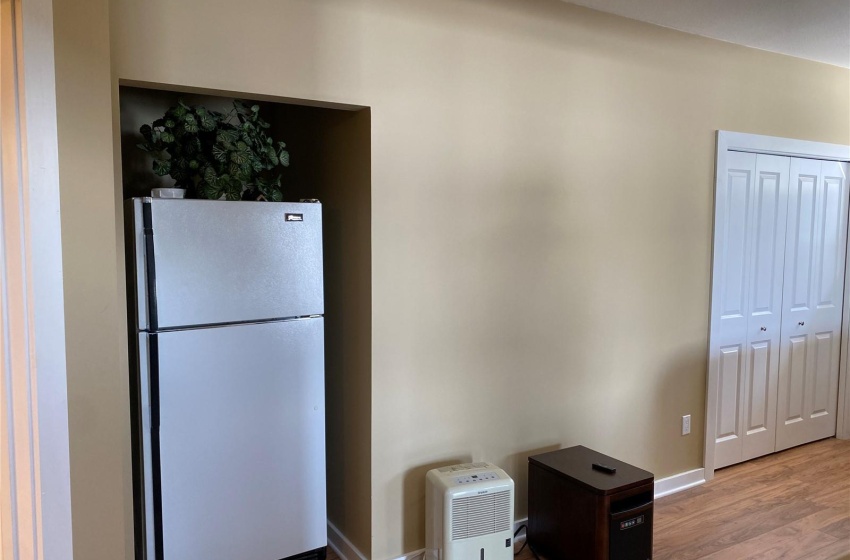 Kitchen featuring light wood-type flooring and white refrigerator