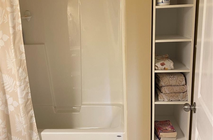 Bathroom featuring tile flooring, shower / tub combo with curtain, and toilet