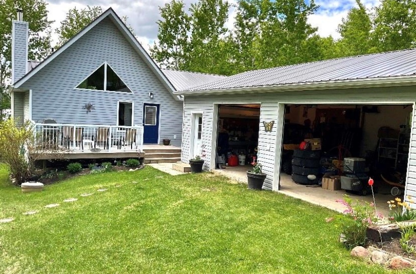 Rear view of property with a yard and a deck